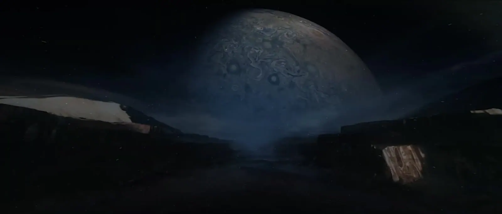 Blue planet seen from a dark landscape