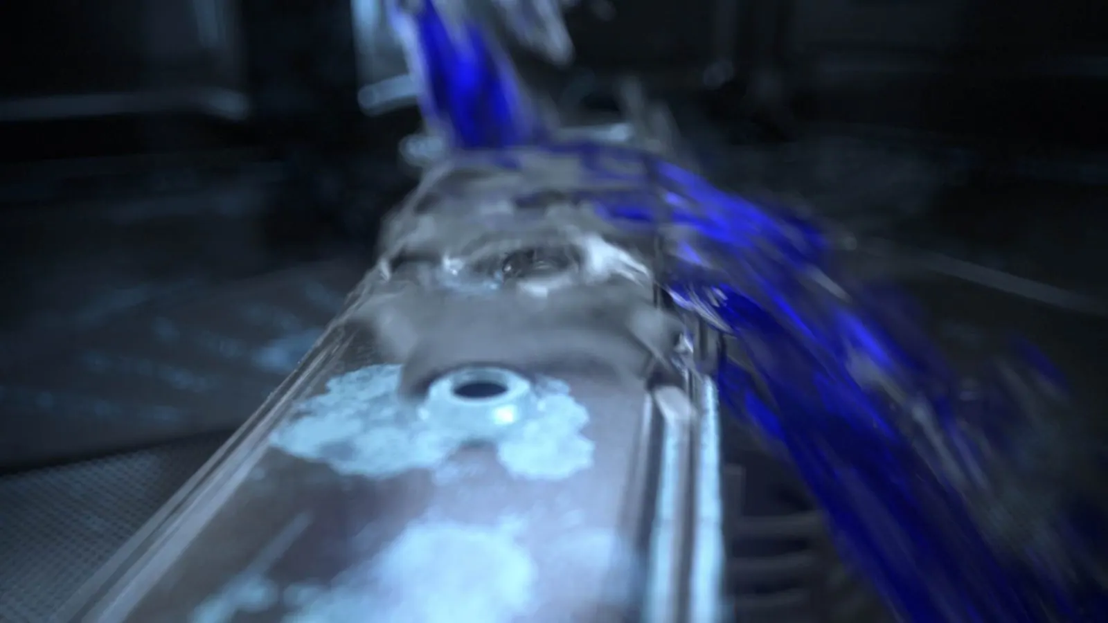 Blue liquid splashing onto a glass