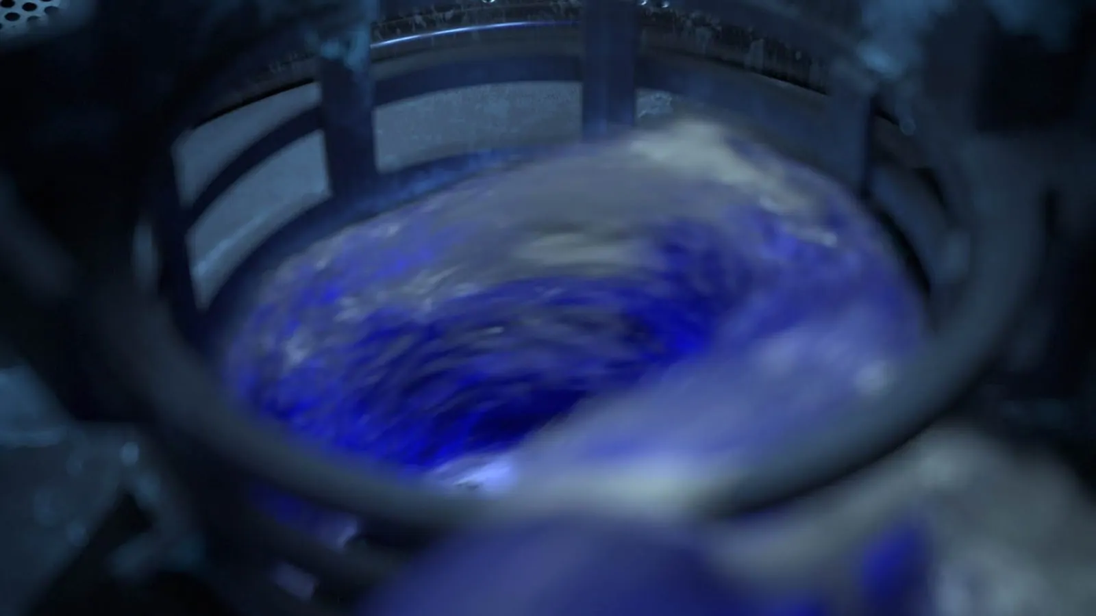 Swirl of blue liquid in the dishwasher basket