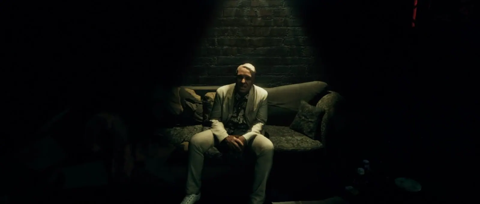 A man sitting on a sofa in the dark