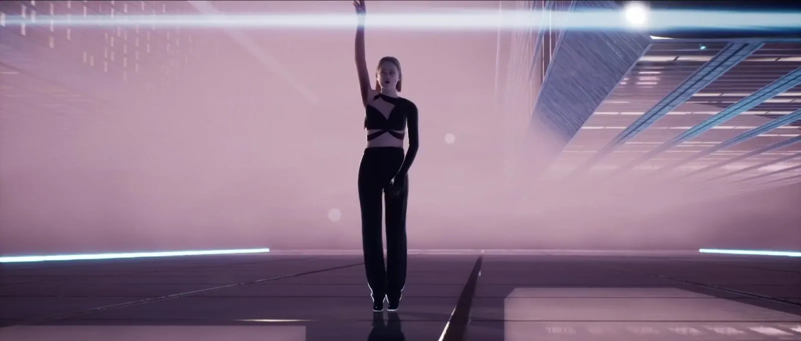 The singer in a pink set crossed by light